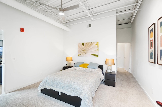 bedroom featuring light carpet, a high ceiling, and ceiling fan