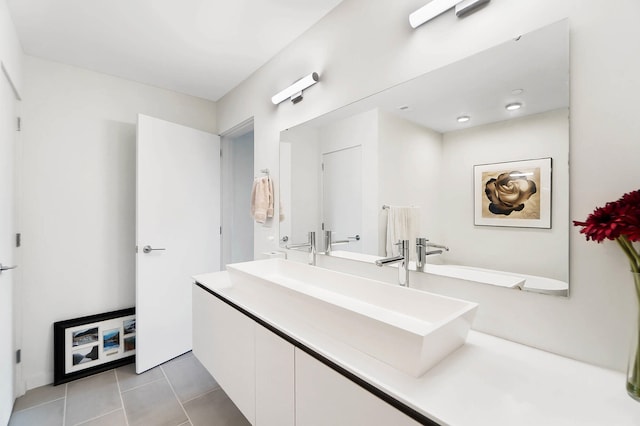 bathroom with tile patterned floors and vanity