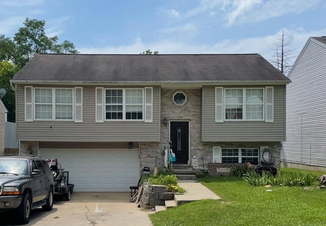 split foyer home featuring a front yard and a garage