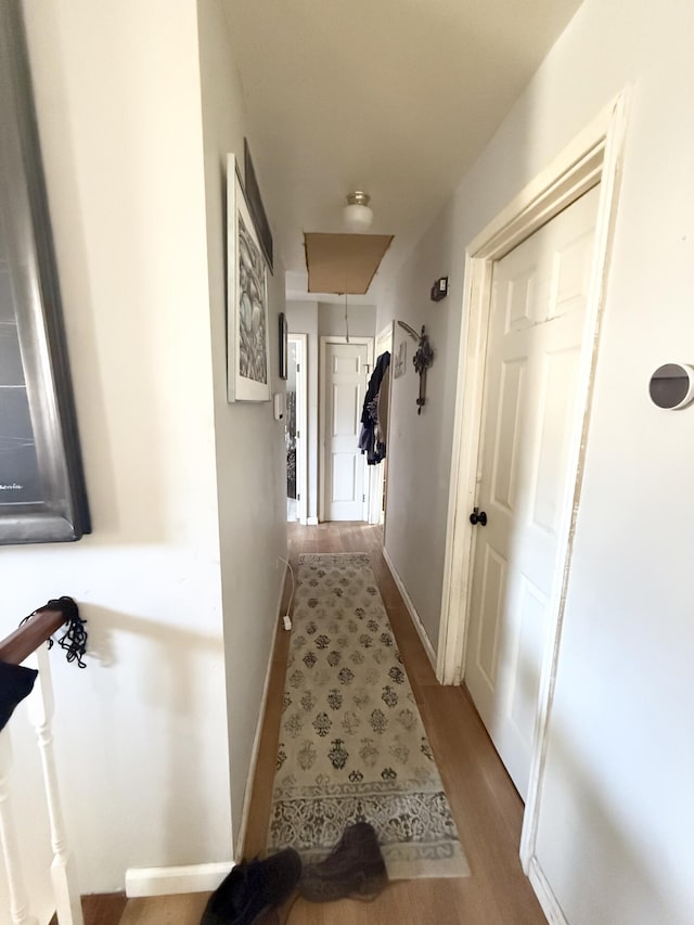 hallway with hardwood / wood-style floors