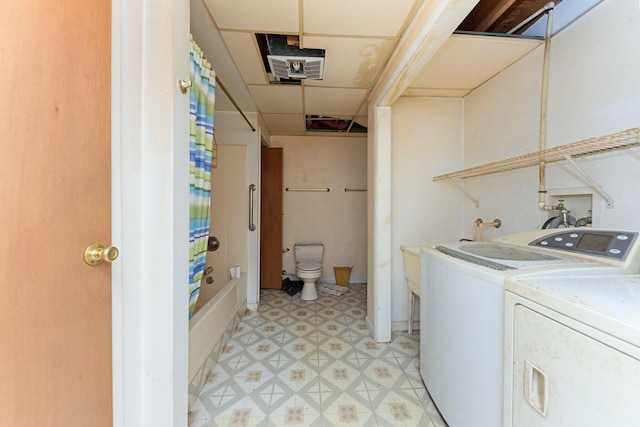 clothes washing area featuring washer and clothes dryer