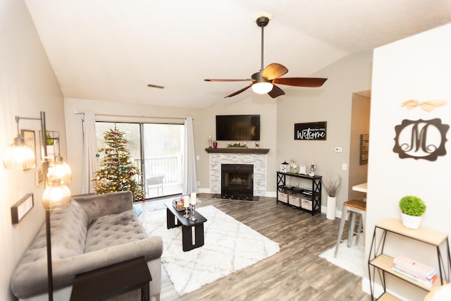 living room featuring a fireplace, ceiling fan, dark hardwood / wood-style flooring, and lofted ceiling