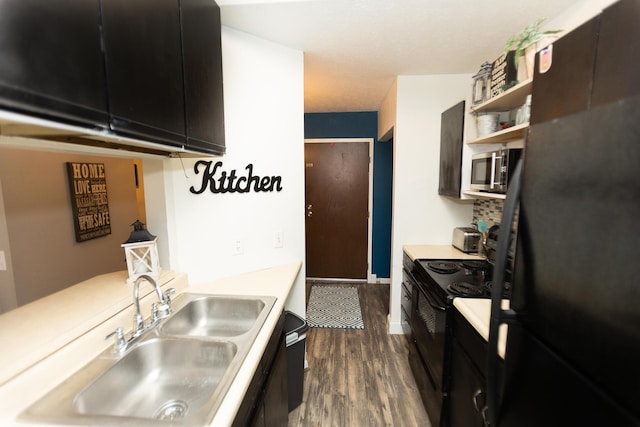 kitchen featuring sink, black appliances, and dark hardwood / wood-style floors