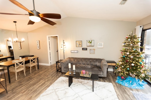 living room featuring ceiling fan with notable chandelier, hardwood / wood-style flooring, and vaulted ceiling