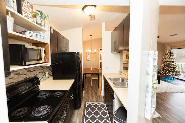 kitchen featuring black appliances, sink, vaulted ceiling, dark brown cabinets, and dark hardwood / wood-style flooring