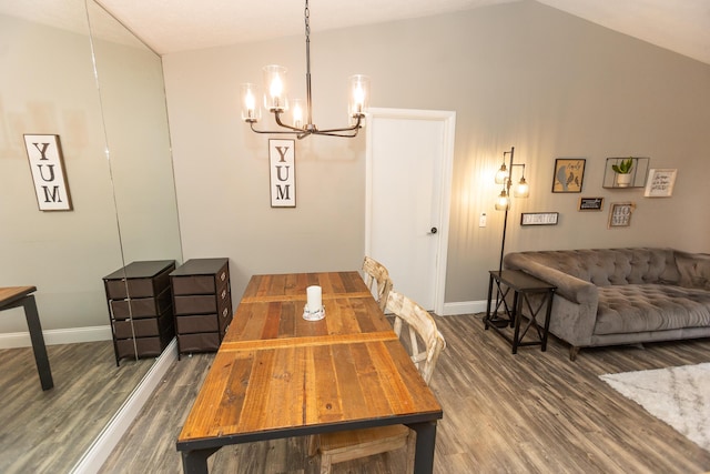 dining room featuring a notable chandelier, dark hardwood / wood-style floors, and lofted ceiling