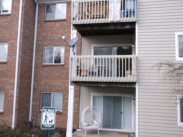 rear view of property featuring a balcony