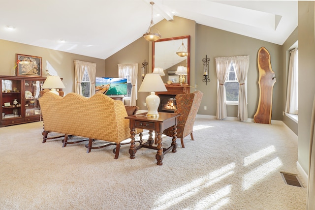 dining area featuring light colored carpet, lofted ceiling with beams, and a wealth of natural light