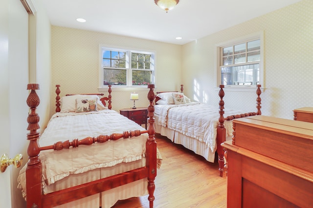 bedroom featuring multiple windows and light hardwood / wood-style flooring