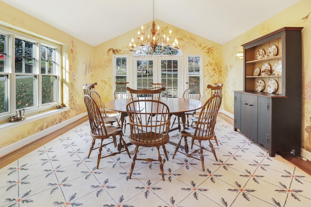 dining area featuring vaulted ceiling, an inviting chandelier, and light hardwood / wood-style flooring