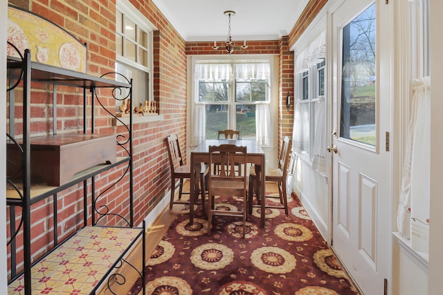 dining area with ornamental molding and brick wall