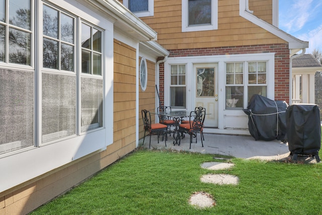 rear view of house with a yard and a patio area