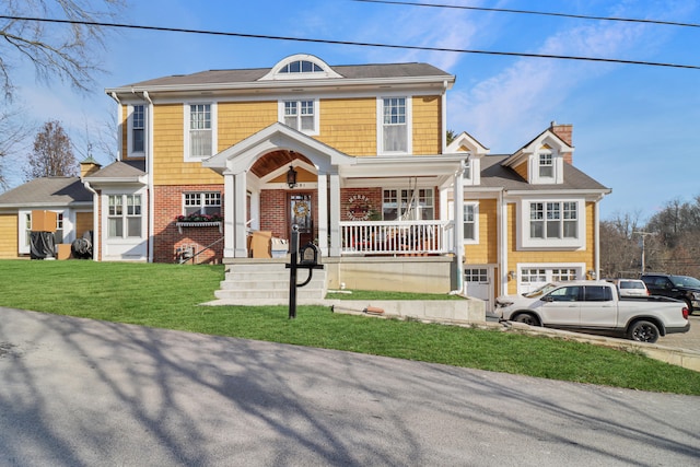 view of front of home with a garage and a front lawn