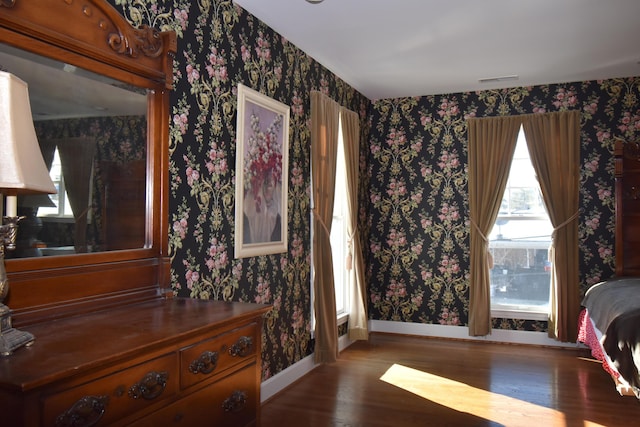 bedroom with dark wood-type flooring