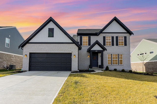 view of front of property with a yard and central AC unit