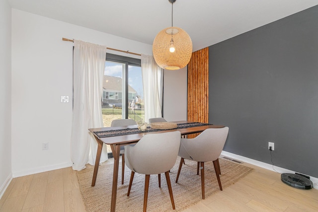 dining space with light hardwood / wood-style floors