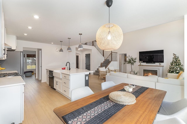 dining area with light hardwood / wood-style flooring and sink