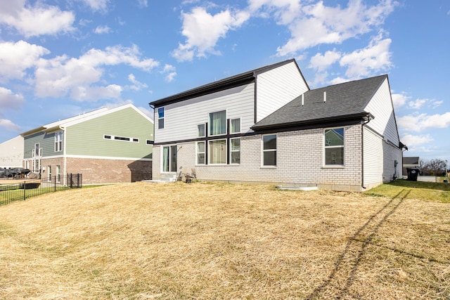 rear view of house featuring a lawn