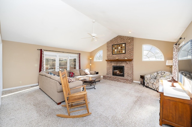 living room featuring a brick fireplace, ceiling fan, light carpet, and vaulted ceiling