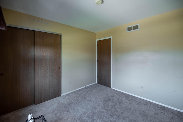 unfurnished bedroom with carpet floors and a closet