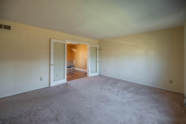 unfurnished bedroom with carpet floors and french doors