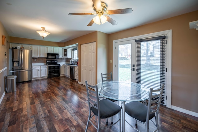 dining room featuring ceiling fan, sink, and dark wood-type flooring