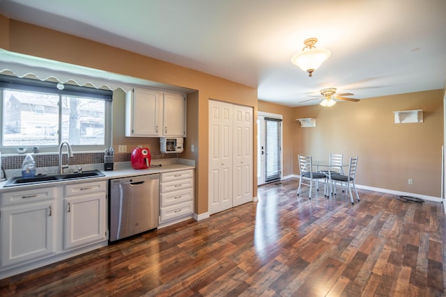 kitchen with white cabinets, ceiling fan, dark wood-type flooring, sink, and dishwasher