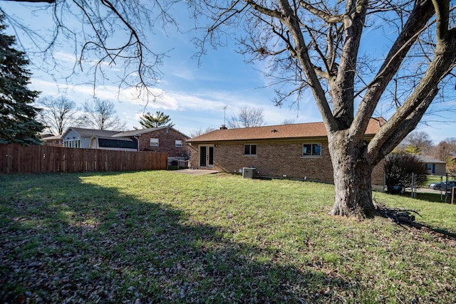 back of property with a yard and a patio area