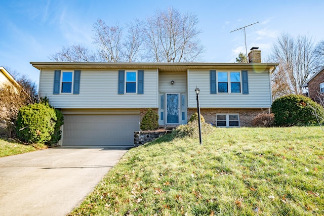 split foyer home featuring a front yard and a garage