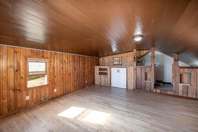 bonus room with wooden walls, light hardwood / wood-style floors, vaulted ceiling, and wooden ceiling