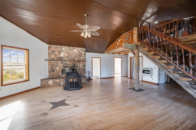 unfurnished living room with heating unit, ceiling fan, wooden ceiling, hardwood / wood-style floors, and a wood stove