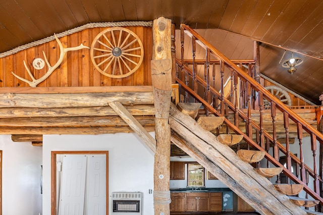 staircase featuring rustic walls, wood ceiling, heating unit, vaulted ceiling, and sink