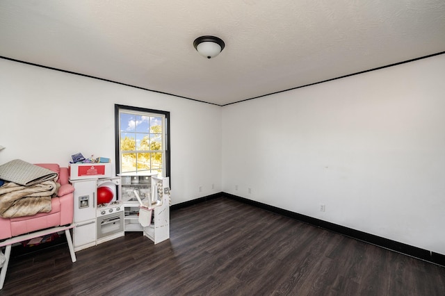 interior space featuring a textured ceiling and dark hardwood / wood-style floors