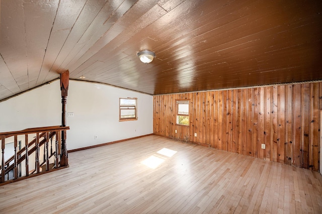 additional living space featuring light hardwood / wood-style flooring, vaulted ceiling, and wood ceiling