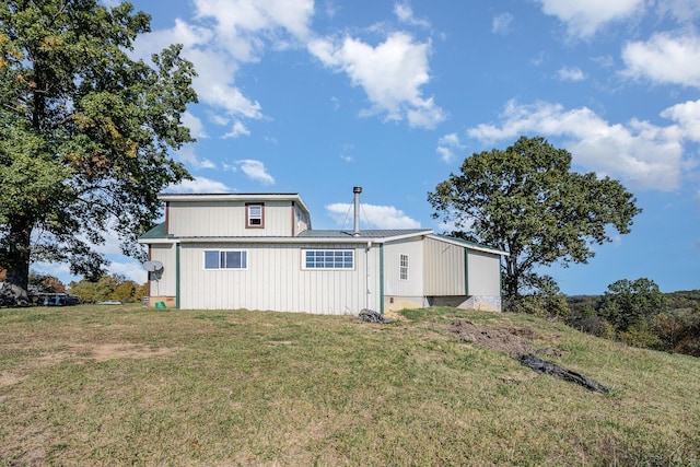 rear view of property with a yard