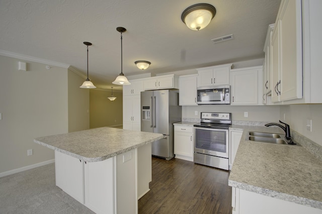 kitchen with pendant lighting, a center island, white cabinets, sink, and stainless steel appliances