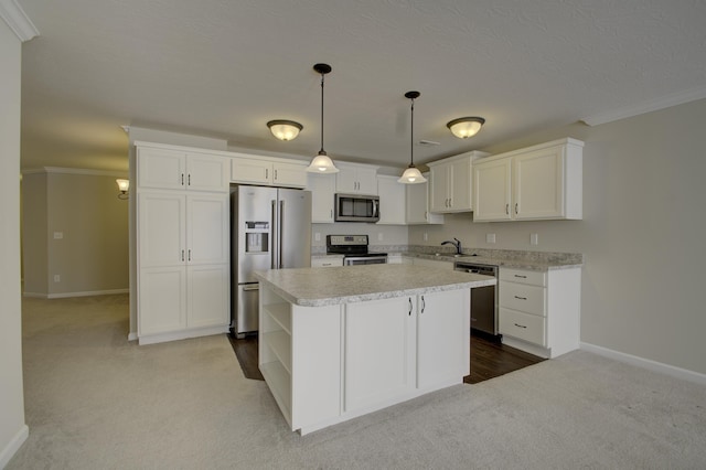 kitchen featuring light carpet, appliances with stainless steel finishes, pendant lighting, a center island, and white cabinetry