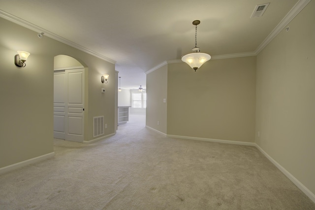 empty room with light colored carpet and ornamental molding