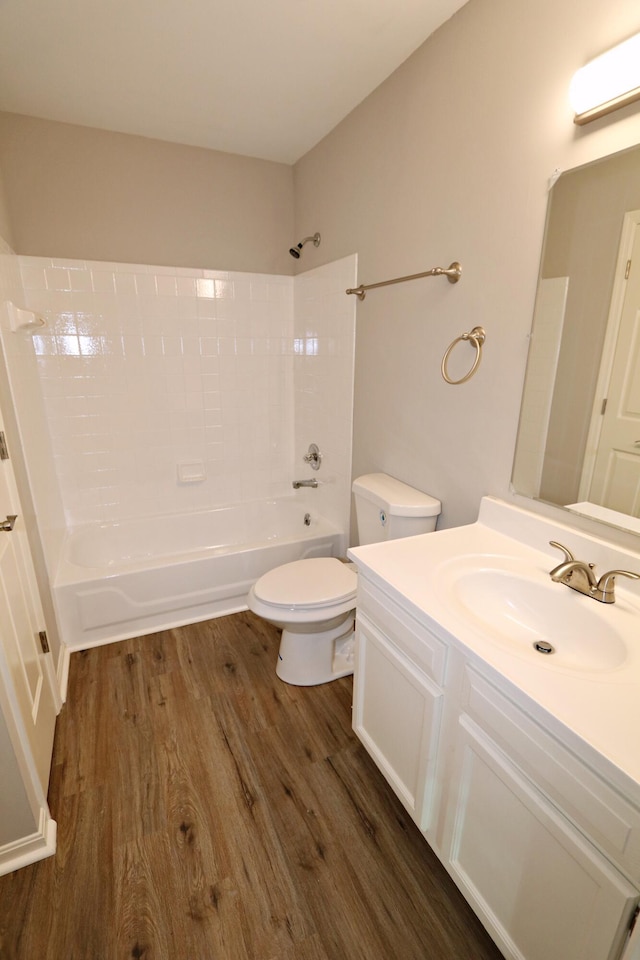 full bathroom with vanity, toilet, wood-type flooring, and bathtub / shower combination