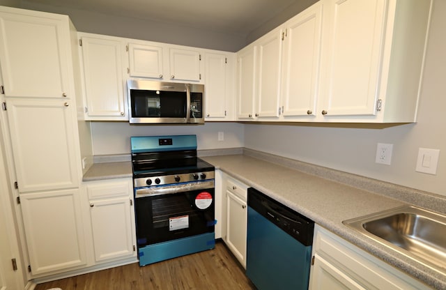 kitchen featuring white cabinetry, dark wood-type flooring, stainless steel appliances, and sink