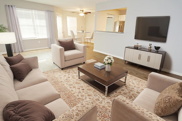 living room featuring ceiling fan and light wood-type flooring