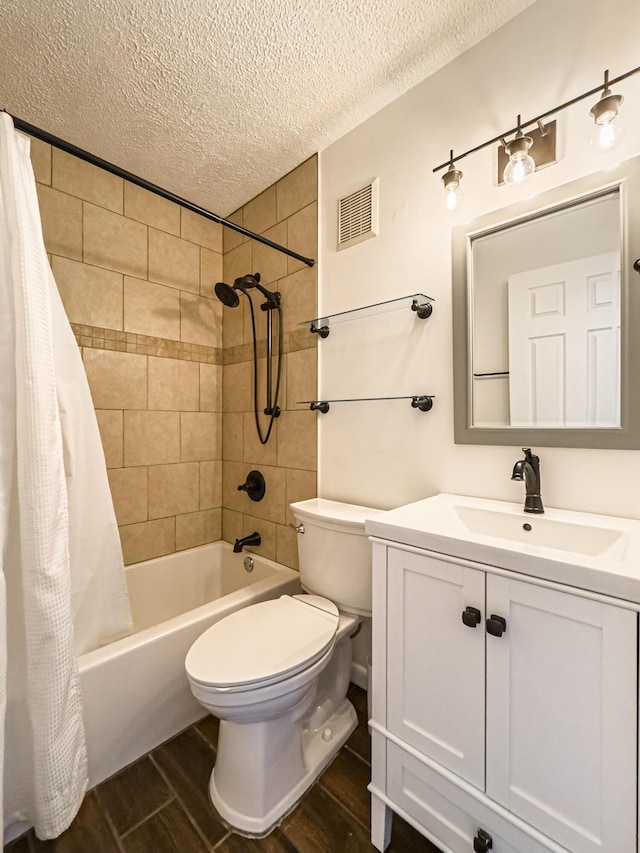 full bathroom with vanity, shower / tub combo, a textured ceiling, and toilet