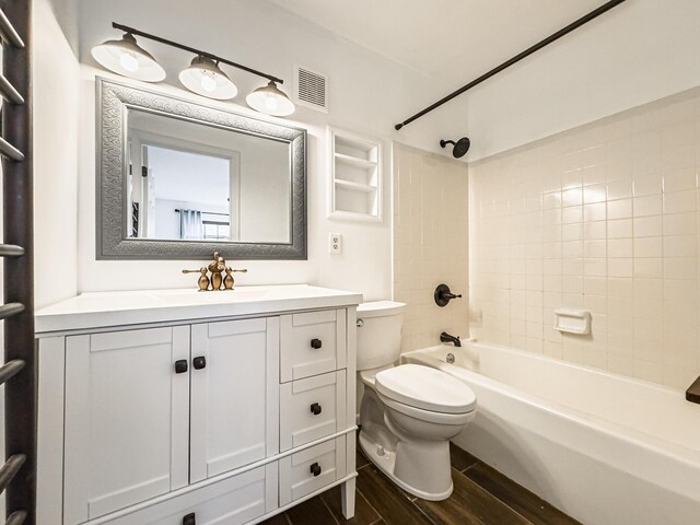 full bathroom featuring vanity, toilet, and tiled shower / bath