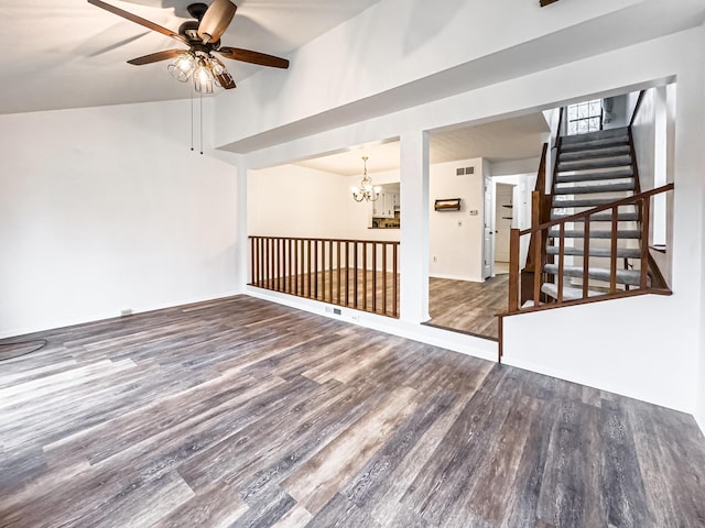 spare room with hardwood / wood-style floors, ceiling fan with notable chandelier, and lofted ceiling