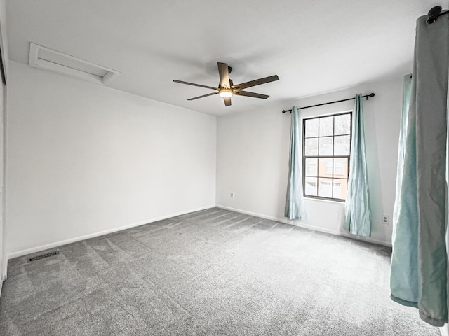 carpeted spare room featuring ceiling fan