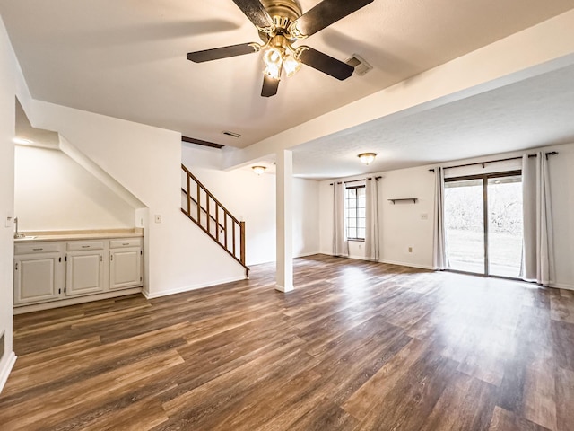 unfurnished living room with hardwood / wood-style flooring and ceiling fan