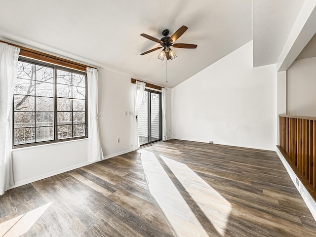 interior space with ceiling fan, lofted ceiling, and dark wood-type flooring