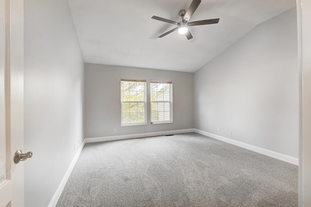 carpeted empty room featuring vaulted ceiling and ceiling fan