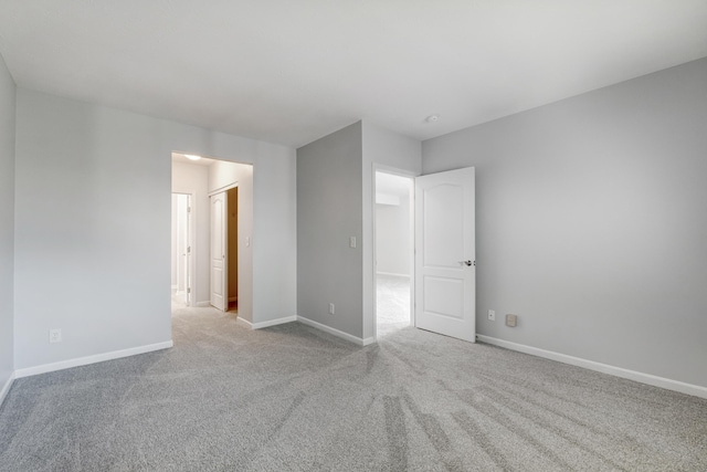 unfurnished room with light colored carpet