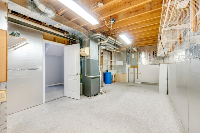 basement with electric panel, heating unit, and carpet floors